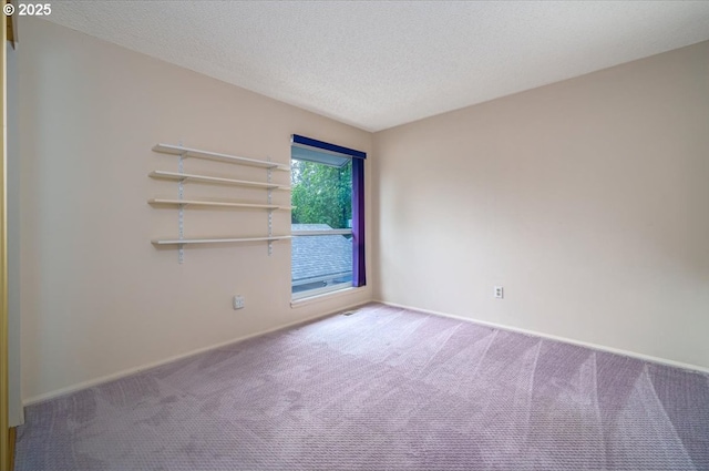 12960 SW 5th St, Beaverton, OR 97005 - carpeted empty room with baseboards and a textured ceiling