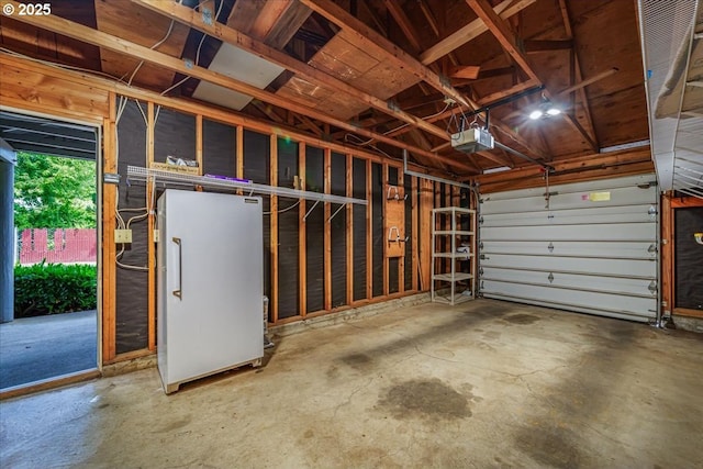 12960 SW 5th St, Beaverton, OR 97005 - garage featuring a garage door opener and freestanding refrigerator