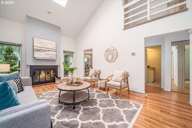 12960 SW 5th St, Beaverton, OR 97005 - living area with high vaulted ceiling, wood finished floors, and a glass covered fireplace