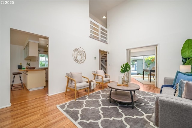 12960 SW 5th St, Beaverton, OR 97005 - living room with plenty of natural light, light wood-style flooring, and a towering ceiling