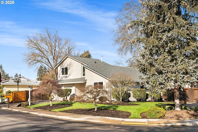 view of front of property featuring driveway, roof with shingles, a front lawn, and fence