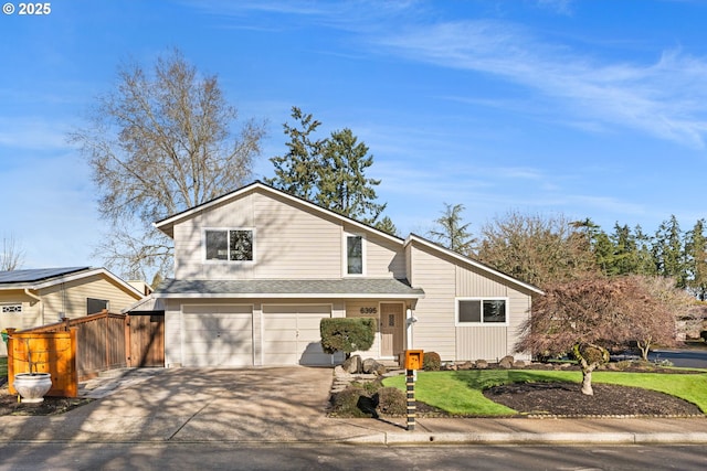 view of front of home with fence, a garage, driveway, and a shingled roof