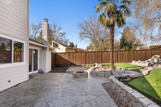 view of patio / terrace featuring a fenced backyard and an outdoor fire pit