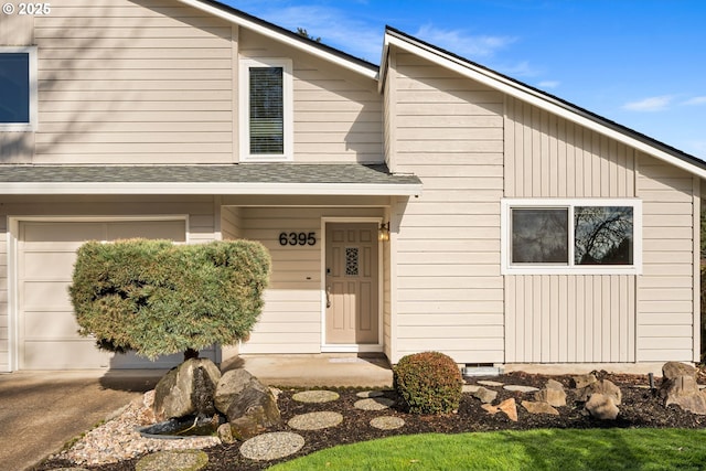 view of front of house with an attached garage and roof with shingles