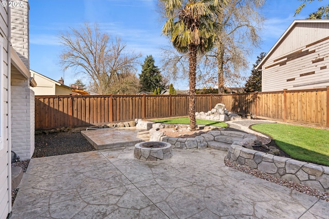 view of patio / terrace with a fire pit and a fenced backyard