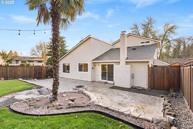 rear view of property featuring a lawn, a fenced backyard, roof with shingles, a chimney, and a patio area