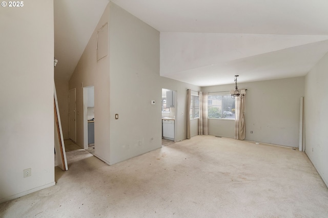 unfurnished living room with high vaulted ceiling and an inviting chandelier