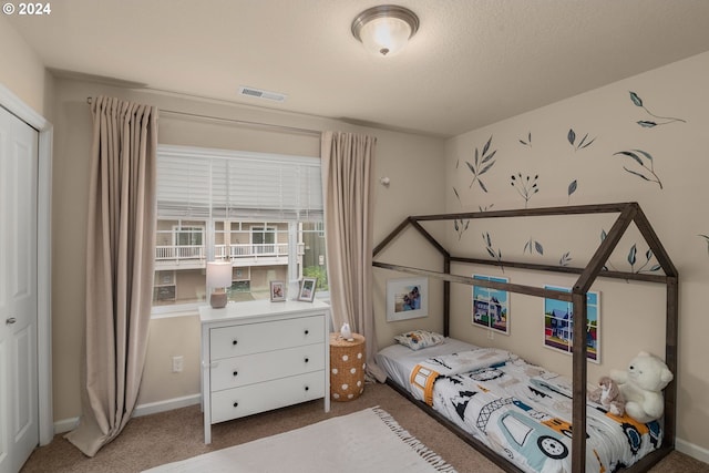 carpeted bedroom with a closet