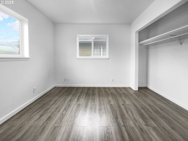 unfurnished bedroom with a closet and dark wood-type flooring