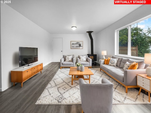 living room with dark hardwood / wood-style flooring and a wood stove