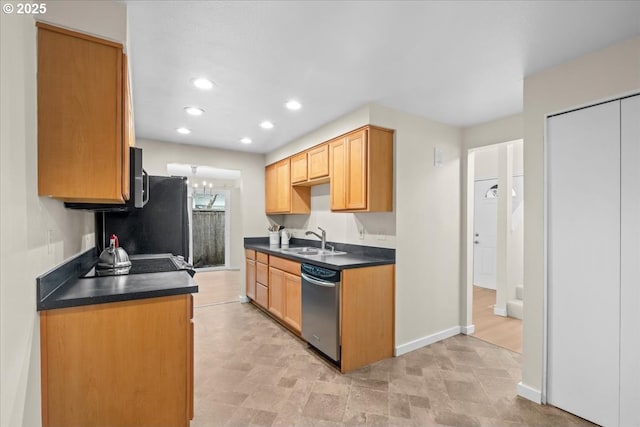 kitchen with baseboards, recessed lighting, dark countertops, stainless steel dishwasher, and a sink
