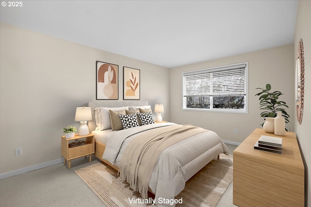 bedroom featuring light carpet and baseboards