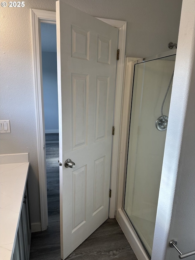 4238 SE 120th Ave, Portland, OR 97266 - bathroom with wood finished floors, a shower stall, vanity, and baseboards