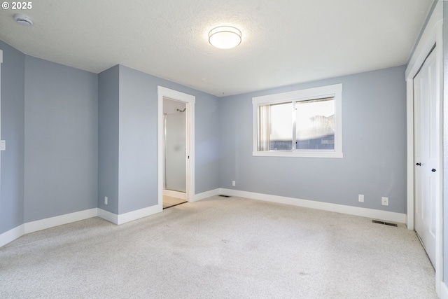 5219 Spring Leaf Ct N, Keizer, OR 97303 - unfurnished bedroom with carpet, a closet, and a textured ceiling