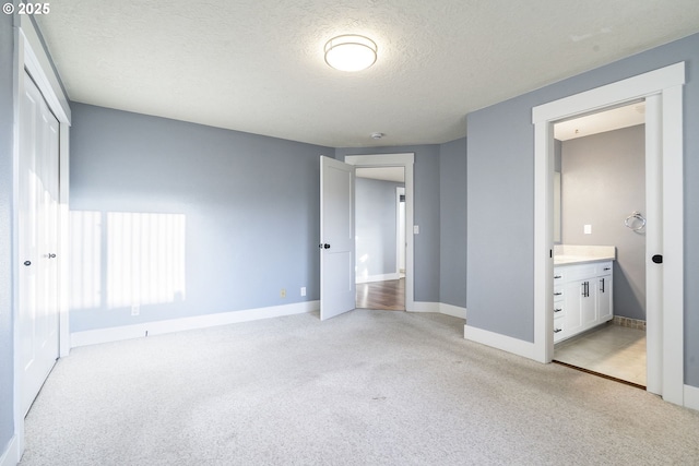 5219 Spring Leaf Ct N, Keizer, OR 97303 - unfurnished bedroom with light carpet, a textured ceiling, a closet, and connected bathroom