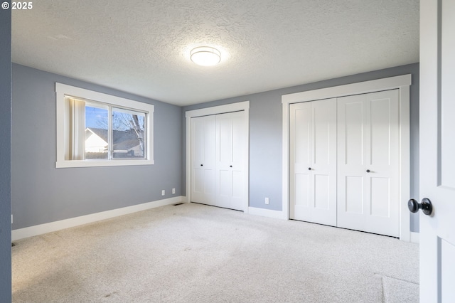 5219 Spring Leaf Ct N, Keizer, OR 97303 - unfurnished bedroom featuring multiple closets, carpet floors, and a textured ceiling