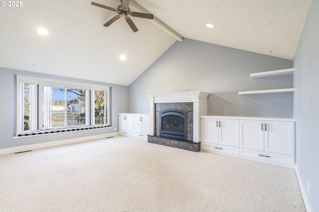 unfurnished living room featuring visible vents, carpet, vaulted ceiling with beams, and a fireplace