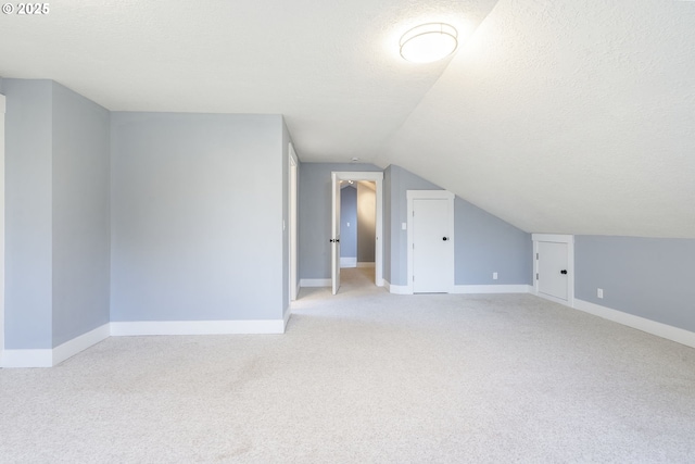 5219 Spring Leaf Ct N, Keizer, OR 97303 - additional living space with a textured ceiling, light carpet, and lofted ceiling