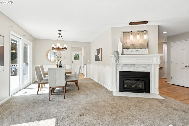 20681 S Wisteria Rd, West Linn, OR 97068 - dining area featuring healthy amount of natural light, carpet floors, a chandelier, and a fireplace