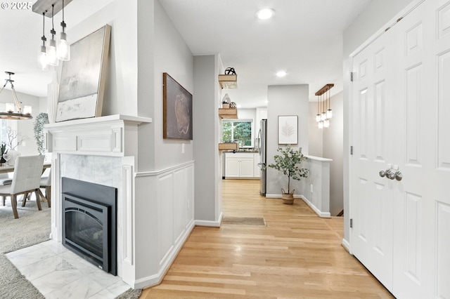 20681 S Wisteria Rd, West Linn, OR 97068 - hallway featuring a chandelier, light wood finished floors, and recessed lighting