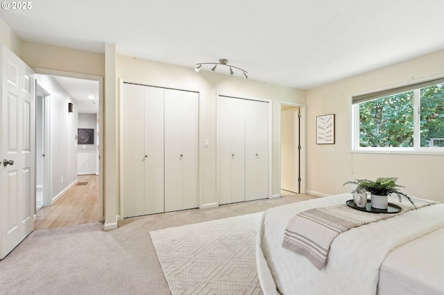20681 S Wisteria Rd, West Linn, OR 97068 - bedroom featuring two closets and light colored carpet