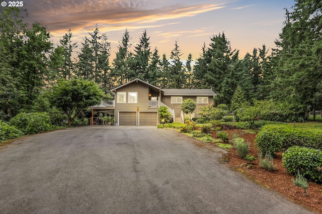 20681 S Wisteria Rd, West Linn, OR 97068 - view of front of property with a garage, driveway, and view of scattered trees