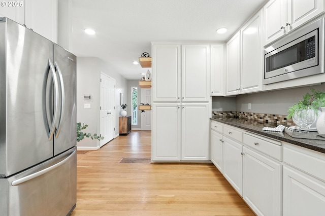 20681 S Wisteria Rd, West Linn, OR 97068 - kitchen featuring stainless steel appliances, light wood-style floors, white cabinets, recessed lighting, and tasteful backsplash