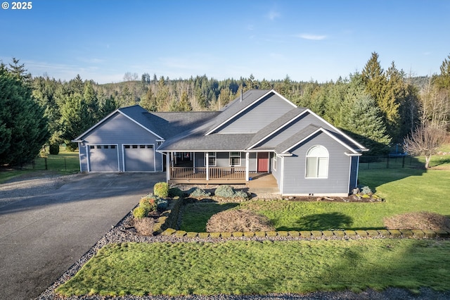 ranch-style house featuring a front lawn, covered porch, and a garage