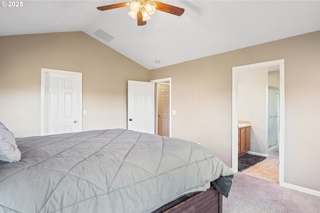 bedroom featuring ceiling fan, light colored carpet, connected bathroom, and lofted ceiling