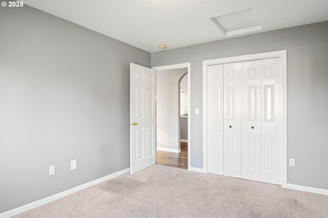 unfurnished bedroom featuring a closet and carpet flooring