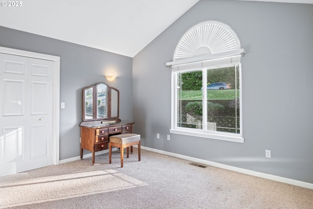 interior space featuring carpet flooring and vaulted ceiling