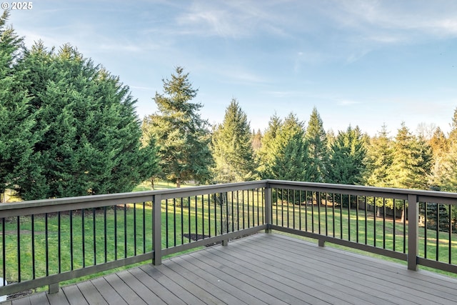 wooden terrace featuring a yard