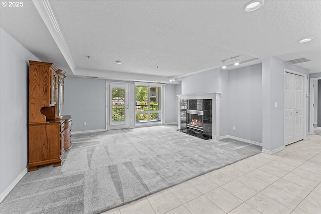 15420 NE Knott St Unit 2, Portland, OR 97230 - unfurnished living room featuring a textured ceiling, light colored carpet, baseboards, a tile fireplace, and light tile patterned floors