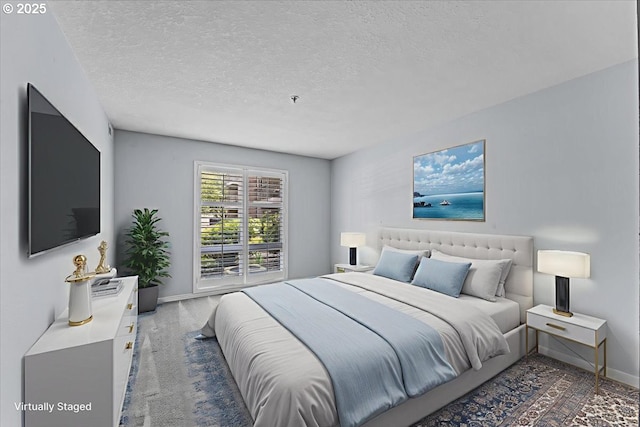 15420 NE Knott St Unit 2, Portland, OR 97230 - bedroom featuring baseboards, a textured ceiling, and carpet floors