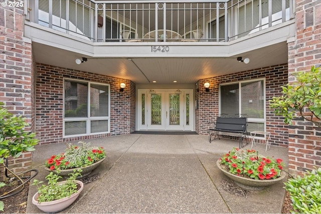 15420 NE Knott St Unit 2, Portland, OR 97230 - view of exterior entry with brick siding, a balcony, french doors, and a patio area