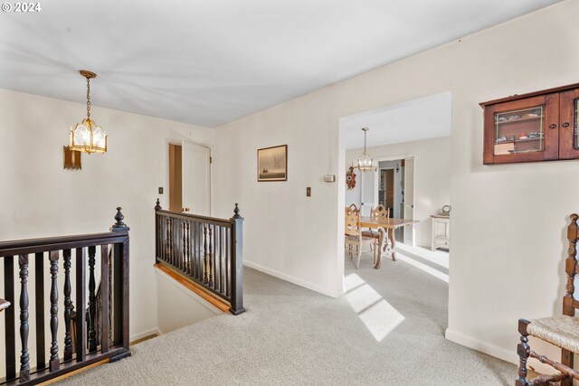 6455 SW Scholls Ferry Rd, Portland, OR 97223 - corridor featuring a chandelier, an upstairs landing, and carpet floors
