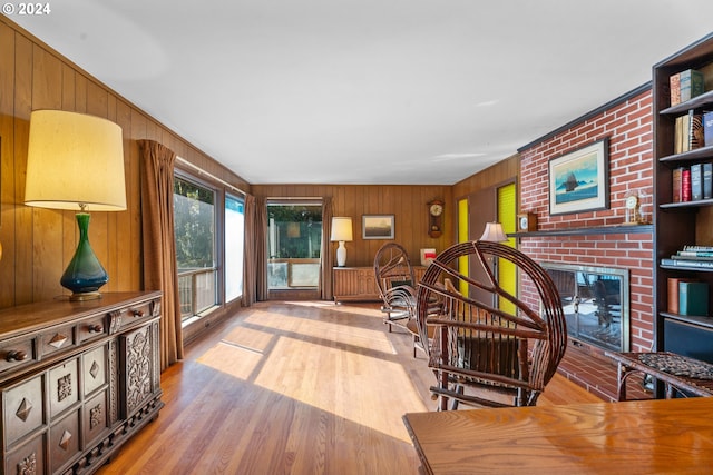 6455 SW Scholls Ferry Rd, Portland, OR 97223 - living room with wooden walls, a brick fireplace, and wood finished floors