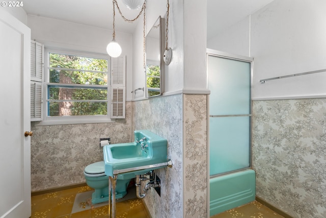 6455 SW Scholls Ferry Rd, Portland, OR 97223 - bathroom with plenty of natural light, bath / shower combo with glass door, and a wainscoted wall