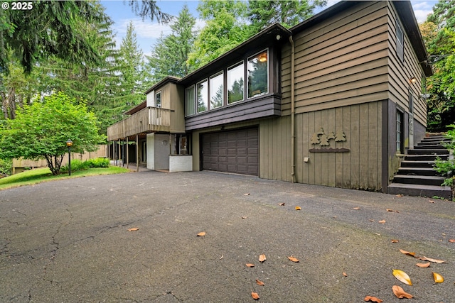 6455 SW Scholls Ferry Rd, Portland, OR 97223 - view of side of home featuring a garage, asphalt driveway, and stairs