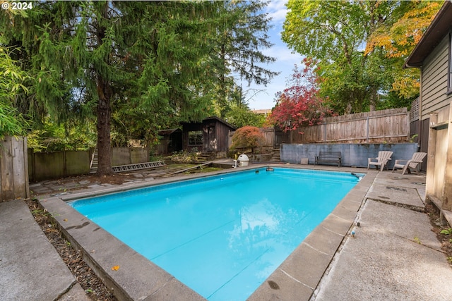 6455 SW Scholls Ferry Rd, Portland, OR 97223 - view of swimming pool featuring a fenced backyard and a storage shed