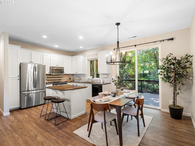 13143 SW Brianne Way, Portland, OR 97223 - kitchen featuring stainless steel appliances, plenty of natural light, dark wood-type flooring, white cabinetry, and recessed lighting