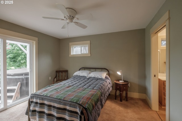 bedroom featuring light colored carpet, multiple windows, access to exterior, and baseboards