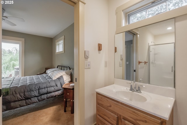 bathroom featuring ceiling fan, vanity, and a shower with door