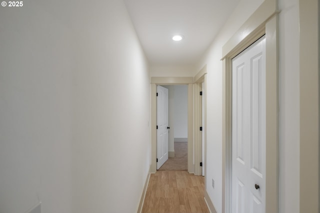 hall with light wood-type flooring, recessed lighting, and baseboards