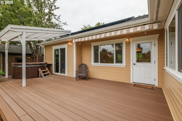wooden deck with a hot tub