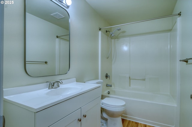 full bathroom with toilet, hardwood / wood-style flooring, vanity, and bathtub / shower combination