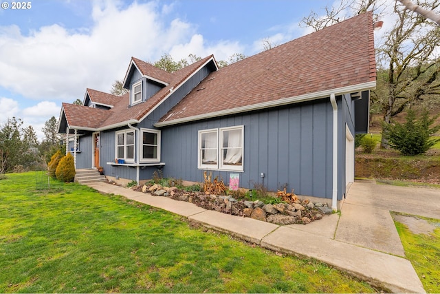 view of side of home featuring a yard and a garage