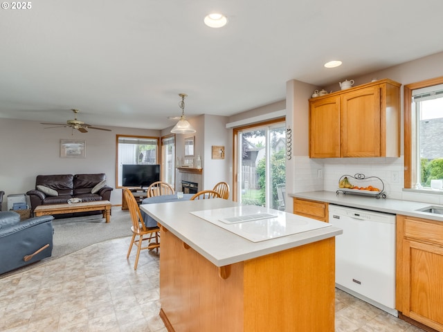 1136 S Pine St, Canby, OR 97013 - kitchen featuring white appliances, open floor plan, a kitchen island, light countertops, and a breakfast bar