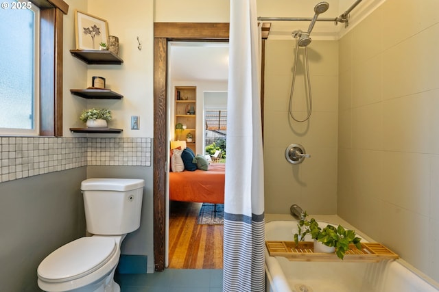 9935 N Lombard St, Portland, OR 97203 - bathroom with tile walls, toilet, shower / tub combo with curtain, and connected bathroom
