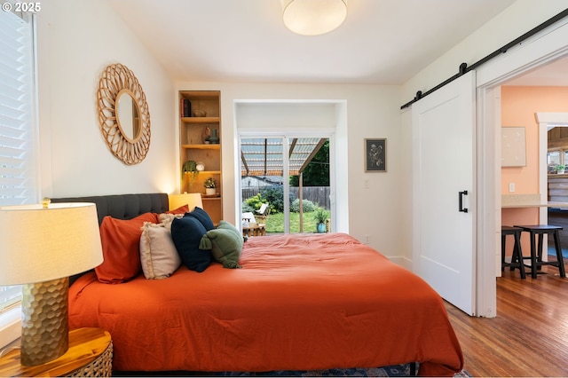 9935 N Lombard St, Portland, OR 97203 - bedroom with a barn door and wood finished floors